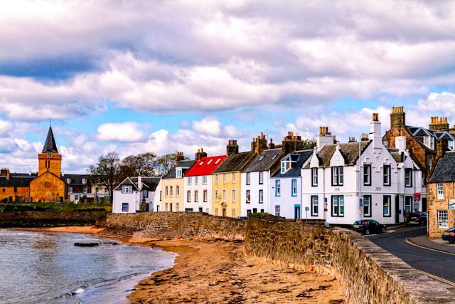 A row of colourful houses along a seaside town shore