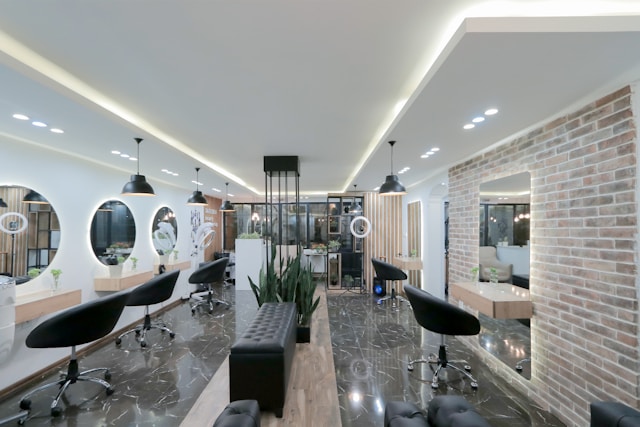 The styling floor at Strand Studio, with marble tiles and a brick feature wall