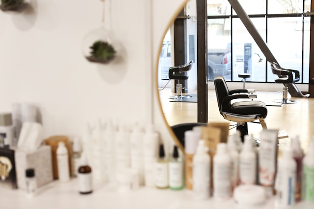 The reception area with a round mirror and shelves of hair products
