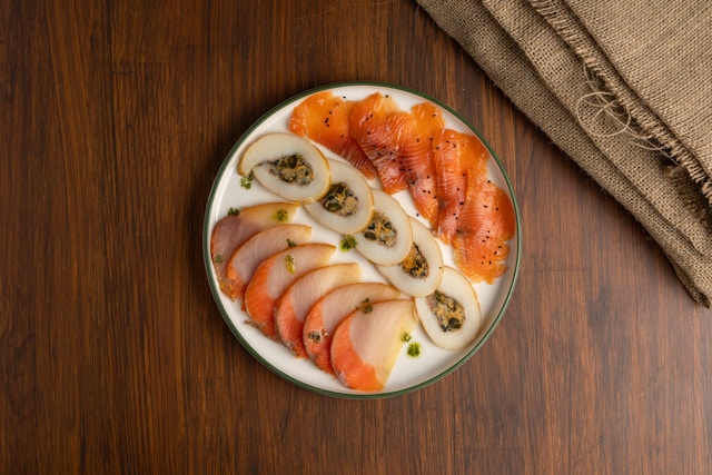 A plate of cold-smoked salmon, sliced