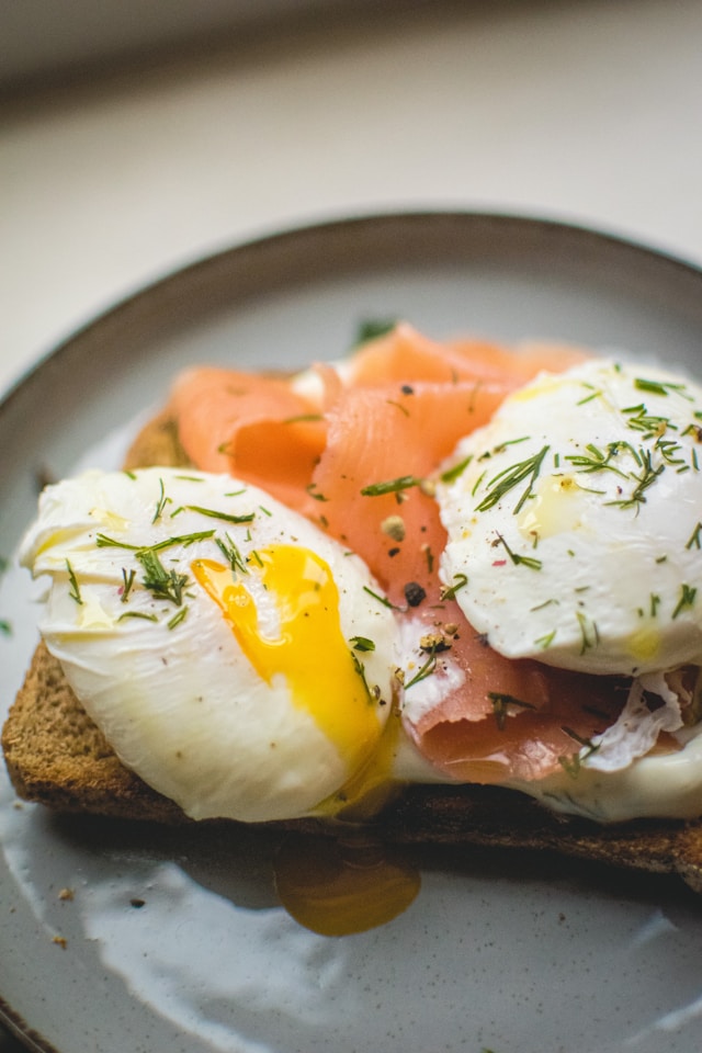 A smokehouse sampler plate of smoked salmon and poached egg on toast