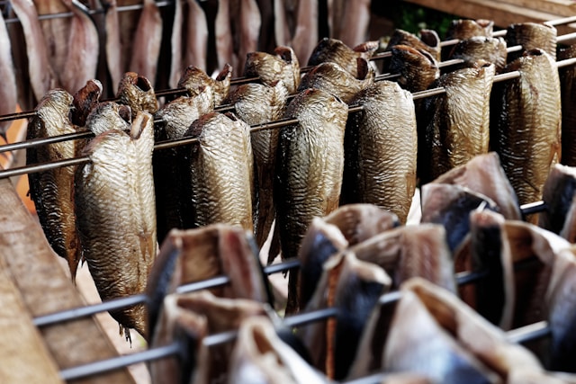 Split kippers hanging on racks in the smoking kiln
